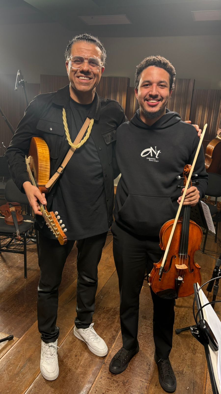 André com a viola no estúdio, ao lado de um músico com bandolim